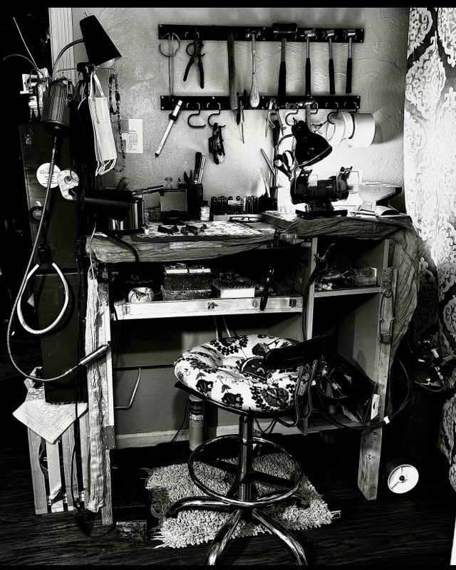 Hands soldering silver at a jeweler's bench